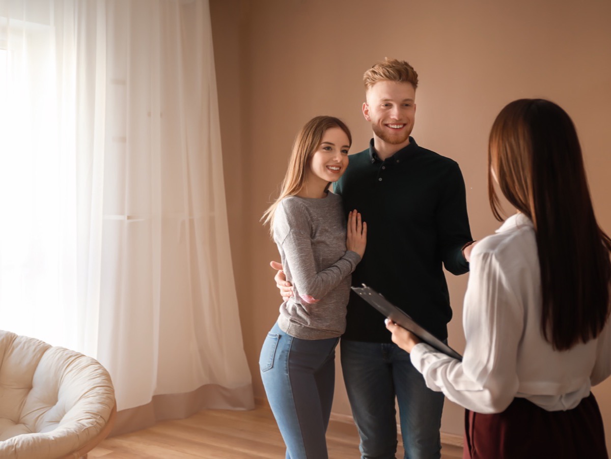 An agent showing a couple through a home